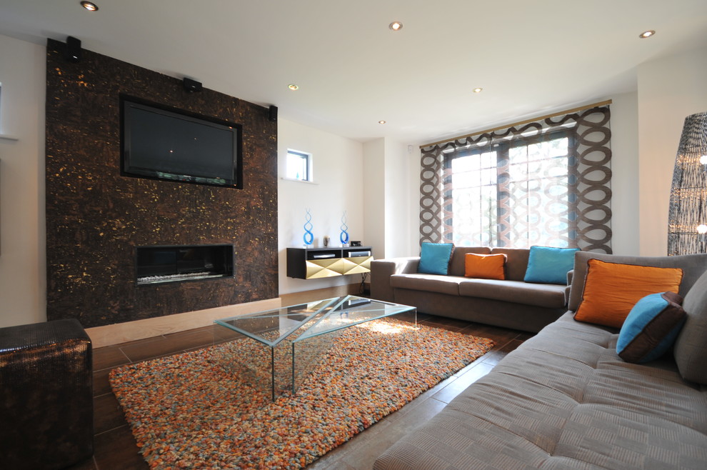 Inspiration for a contemporary living room remodel in Manchester with a ribbon fireplace and a media wall