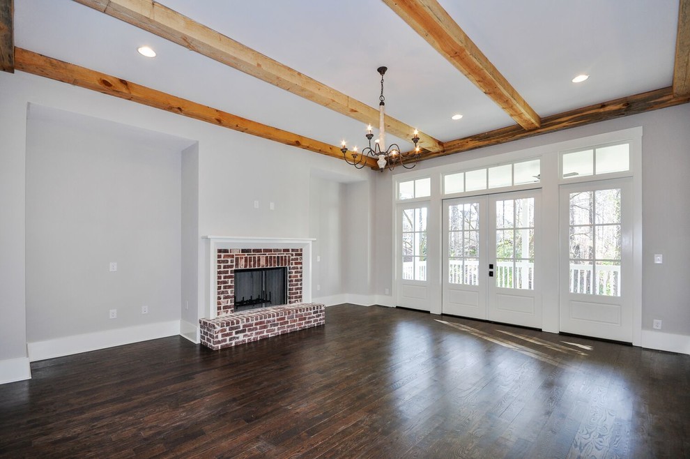 Living room - mid-sized rustic formal and open concept dark wood floor and brown floor living room idea in Atlanta with white walls, a standard fireplace, a brick fireplace and no tv