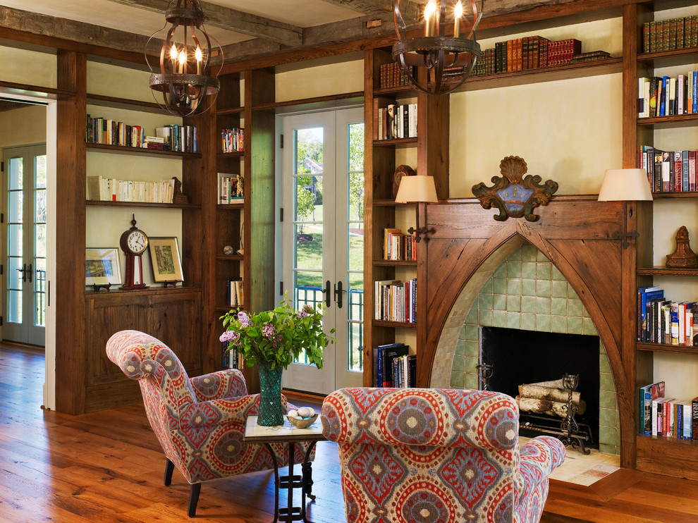 Inspiration for a mediterranean dark wood floor living room library remodel in DC Metro with a standard fireplace and a tile fireplace