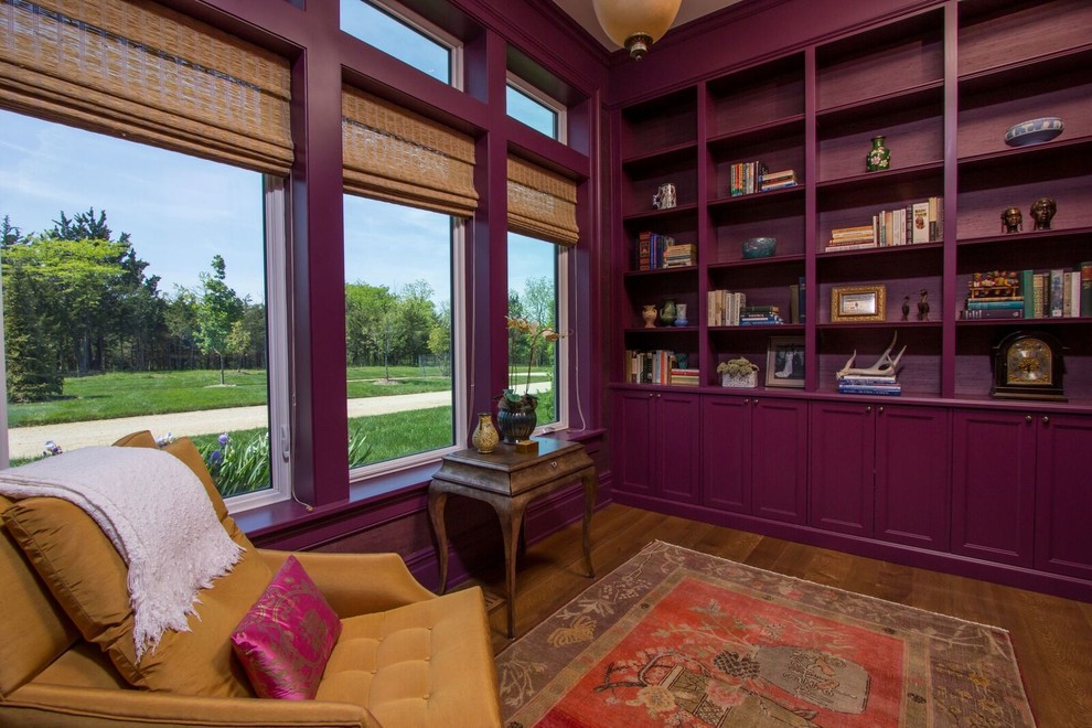 Large trendy open concept medium tone wood floor and brown floor living room library photo in Other with purple walls, no fireplace and no tv
