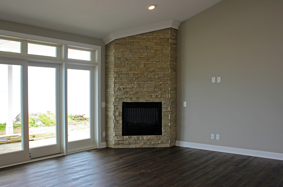 Inspiration for a medium sized beach style formal enclosed living room in Cleveland with grey walls, dark hardwood flooring, a corner fireplace, a stone fireplace surround, no tv and brown floors.