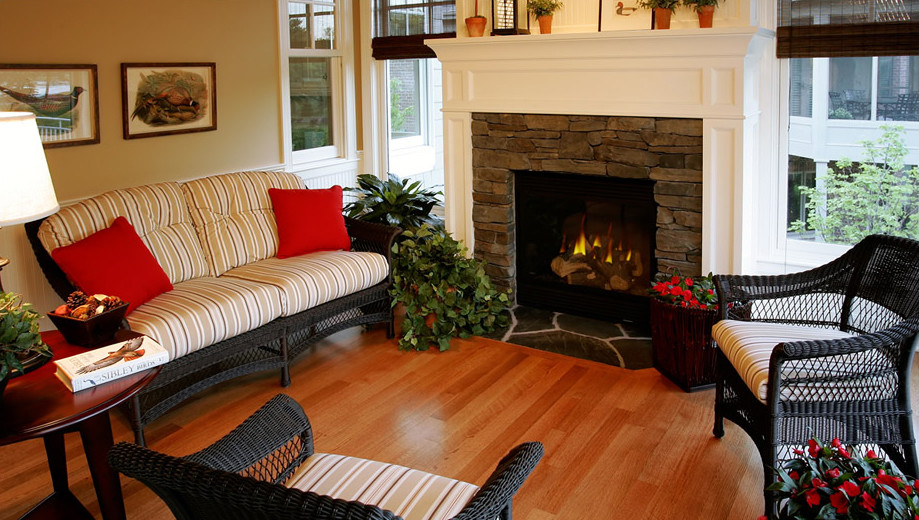 Photo of a medium sized classic enclosed living room in Minneapolis with beige walls, medium hardwood flooring, a standard fireplace and a stone fireplace surround.