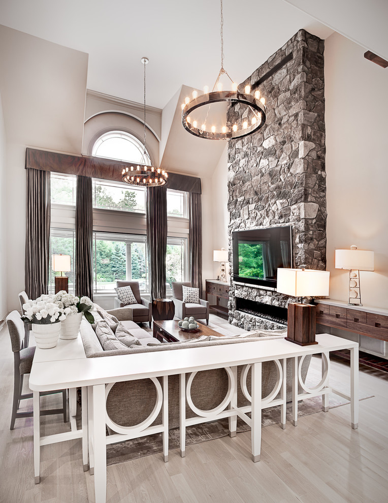 Huge transitional open concept light wood floor living room photo in New York with gray walls, a ribbon fireplace, a stone fireplace and a wall-mounted tv