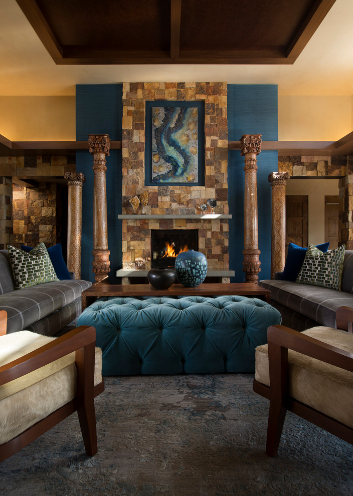Aménagement d'un grand salon classique ouvert avec un mur bleu, un sol en ardoise, une cheminée standard, un manteau de cheminée en pierre et aucun téléviseur.