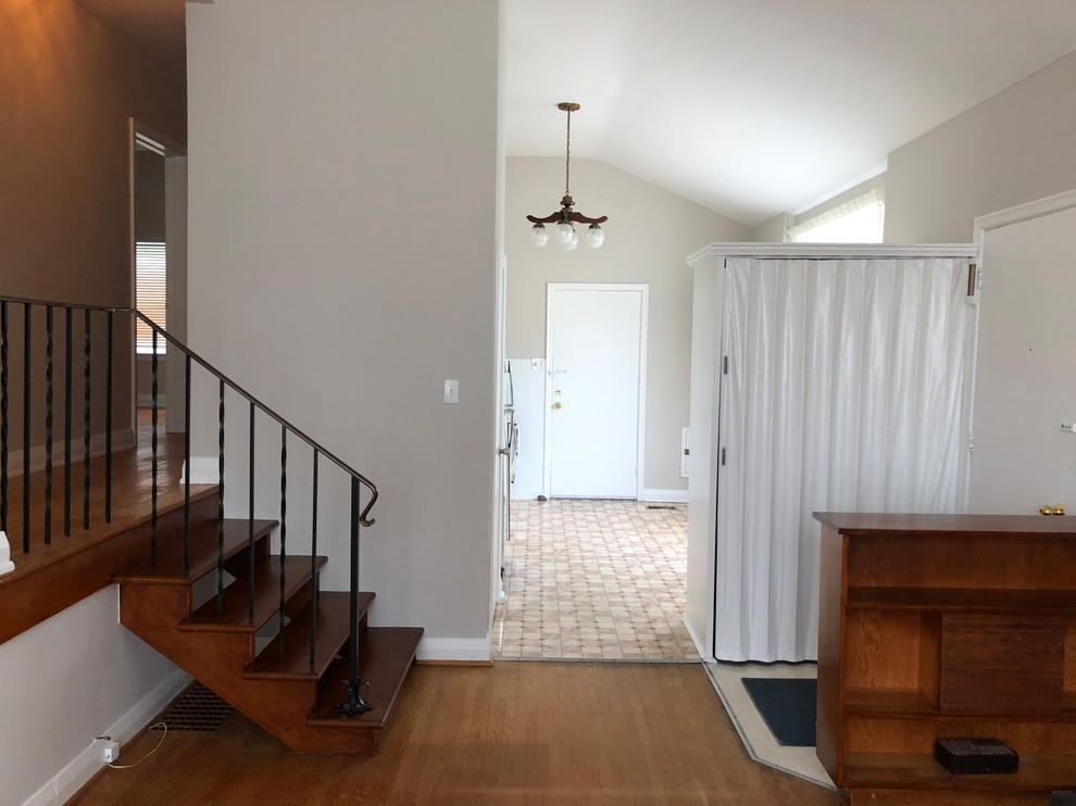 Medium sized midcentury open plan living room in Toronto with grey walls and medium hardwood flooring.