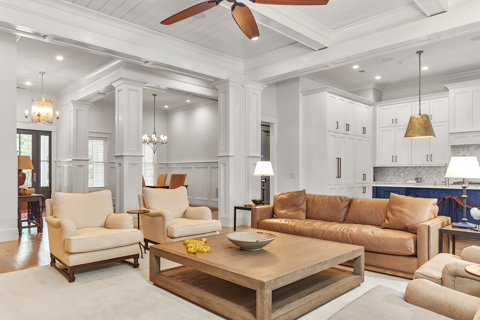 Large traditional open plan living room in Charleston with medium hardwood flooring, a brick fireplace surround, a built-in media unit, beige floors and a standard fireplace.