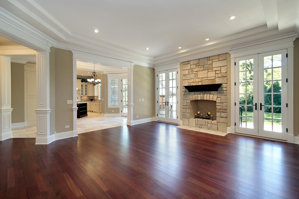 Inspiration for a large classic formal enclosed living room in Atlanta with beige walls, dark hardwood flooring, a standard fireplace, a stone fireplace surround, no tv and brown floors.