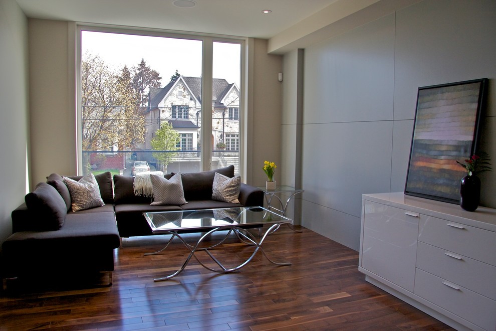 Inspiration for a small contemporary open plan living room in Toronto with beige walls and medium hardwood flooring.