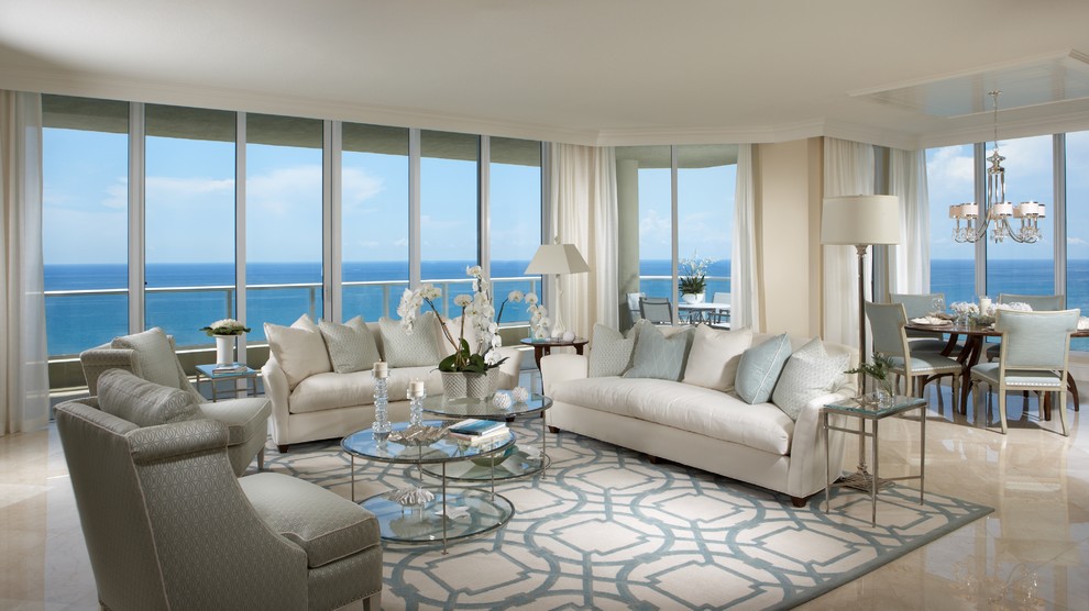 Large beach style marble floor living room photo in Miami with beige walls