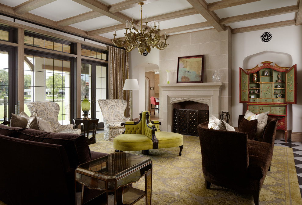 На фото: большая парадная, изолированная гостиная комната в классическом стиле с фасадом камина из камня, белыми стенами, стандартным камином и коричневым диваном