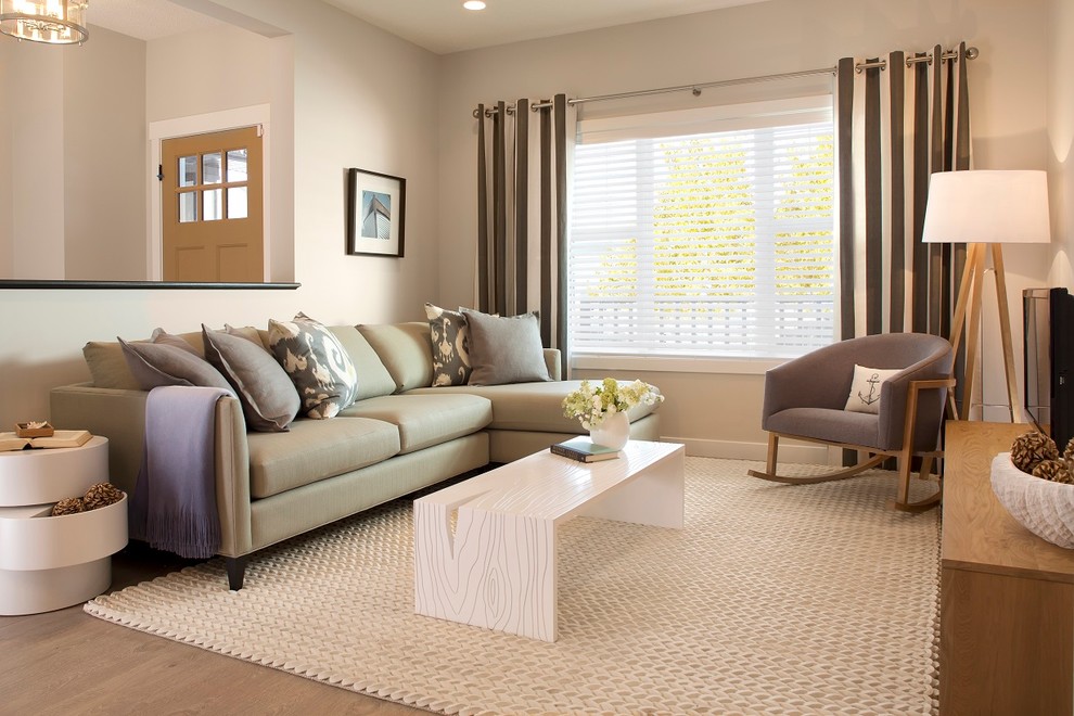 This is an example of a medium sized contemporary enclosed living room in Edmonton with grey walls and a freestanding tv.