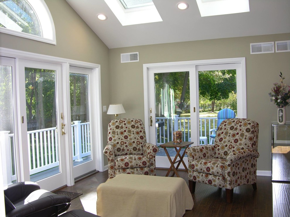 Medium sized open plan living room in New York with beige walls and dark hardwood flooring.