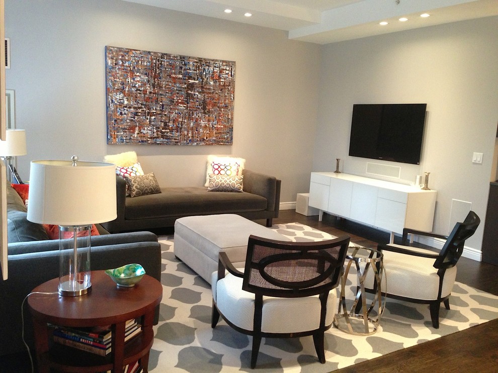 Large trendy medium tone wood floor living room photo in New York with gray walls