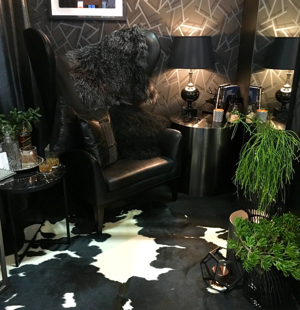 Example of a trendy black floor living room design in Sydney with black walls