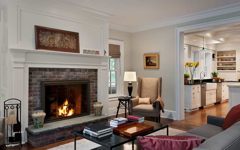 Inspiration for a traditional enclosed living room in New York with beige walls, a standard fireplace, a brick fireplace surround, no tv and feature lighting.