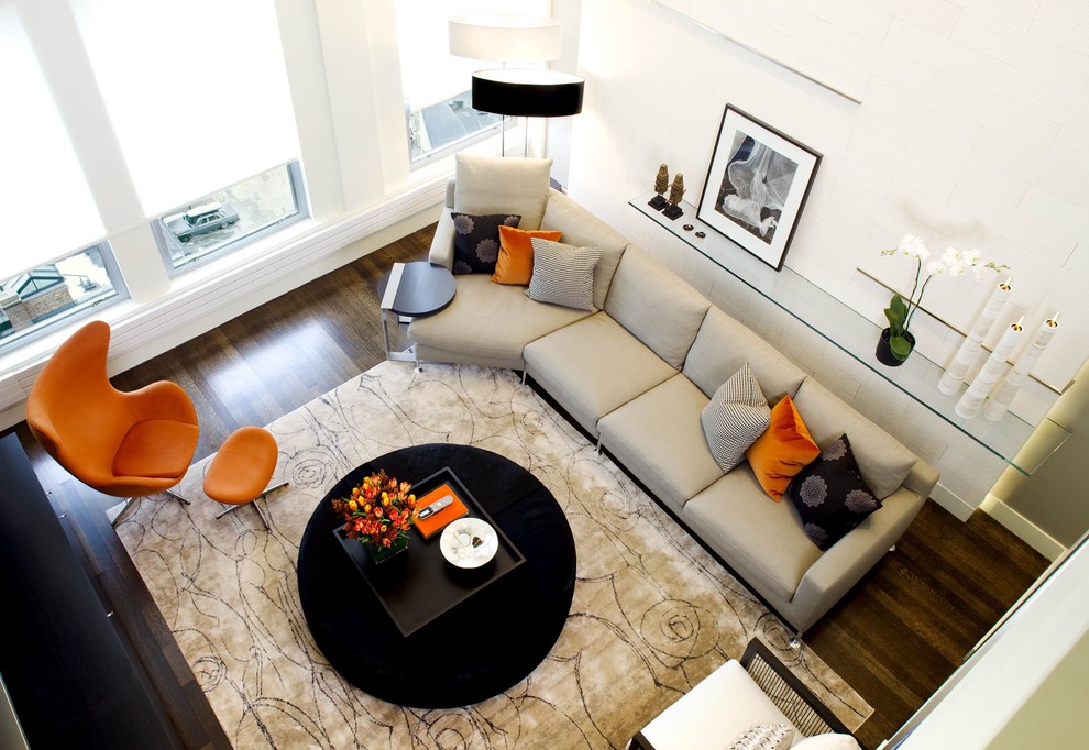 Example of a trendy loft-style dark wood floor living room design in Boston with beige walls