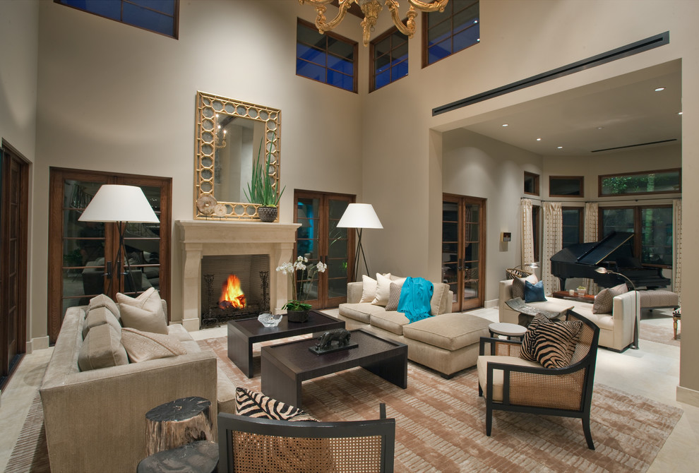 This is an example of a large contemporary open plan living room in Orange County with a music area, a standard fireplace, beige walls, limestone flooring and no tv.