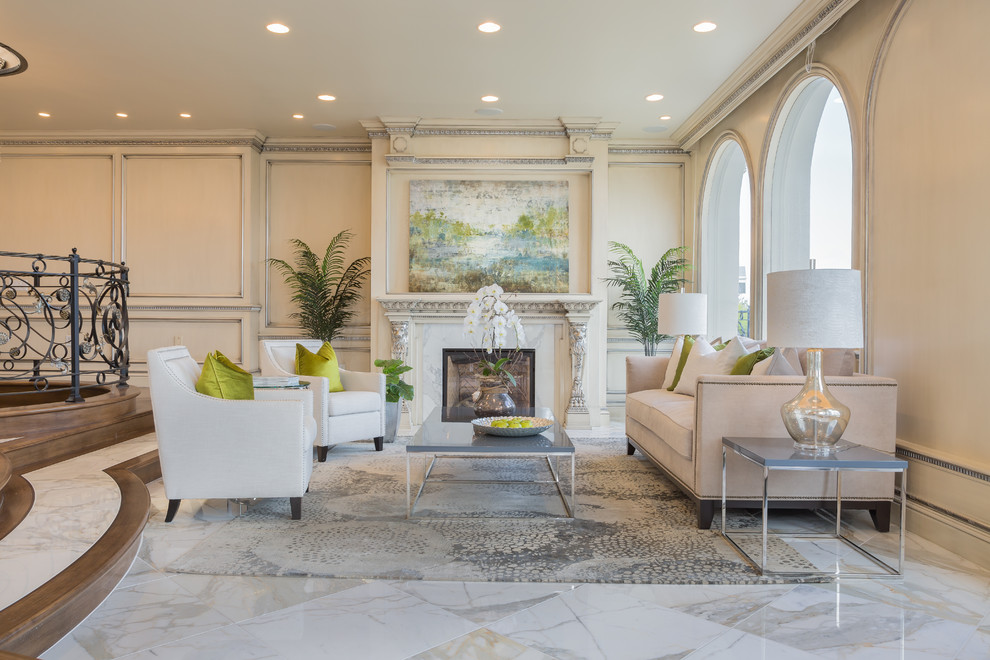 Inspiration for a large transitional formal and enclosed marble floor living room remodel in Orange County with beige walls, a standard fireplace, no tv and a tile fireplace