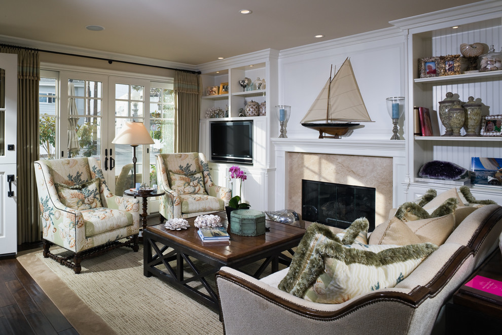 Beach style living room in Orange County with a standard fireplace and a built-in media unit.