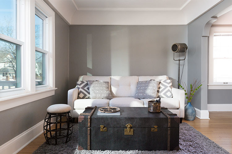 Small urban open concept light wood floor and brown floor living room photo in Milwaukee with gray walls and a tv stand