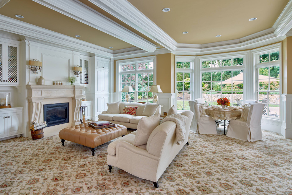 Design ideas for a classic open plan living room in Boston with yellow walls, carpet, a standard fireplace, beige floors, a drop ceiling and wainscoting.