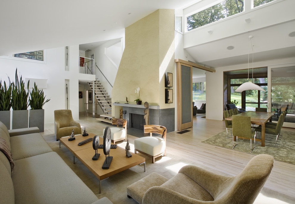 This is an example of a contemporary open plan living room in Boston with a standard fireplace.