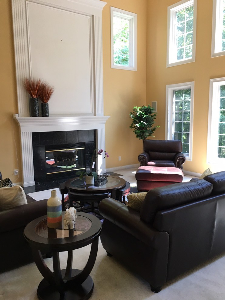 Photo of a medium sized classic formal enclosed living room in Cincinnati with yellow walls, carpet, a standard fireplace, a stone fireplace surround, no tv and beige floors.