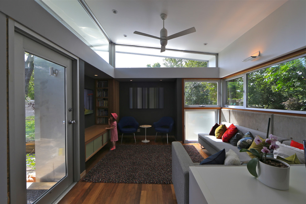 Exemple d'un petit salon tendance ouvert avec un sol en bois brun, aucune cheminée et un téléviseur fixé au mur.