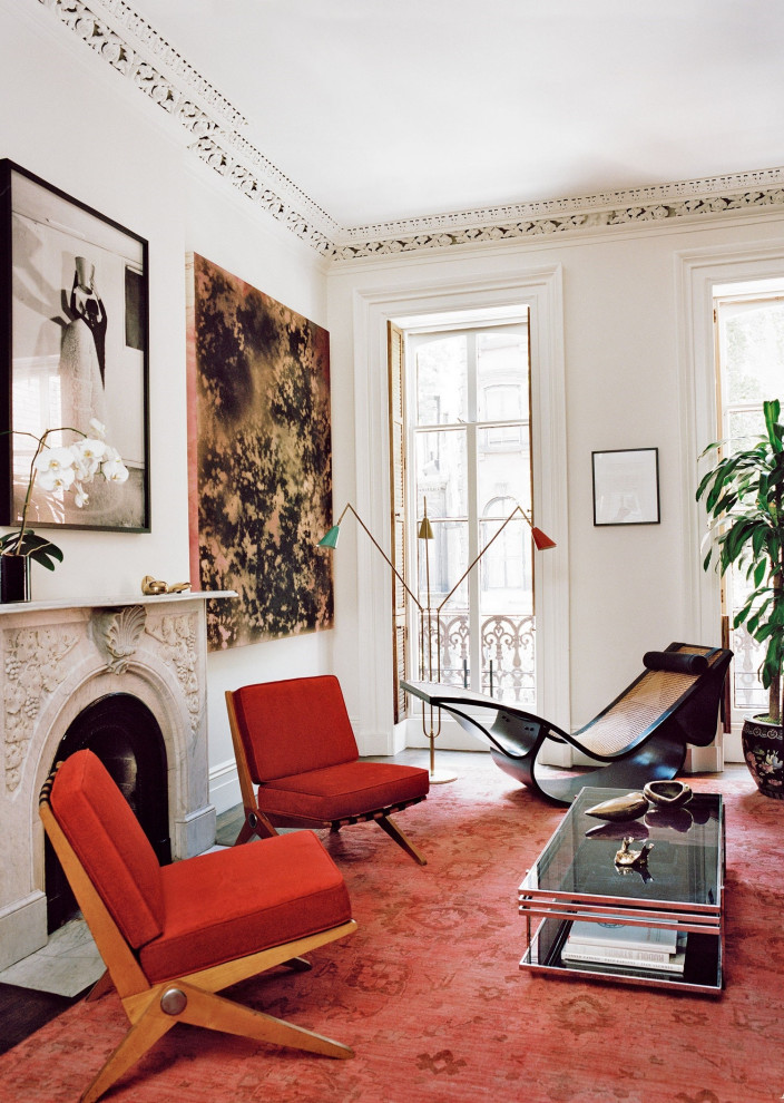 Example of a mid-sized eclectic formal and enclosed living room design in New Orleans with white walls, a standard fireplace, a plaster fireplace and no tv