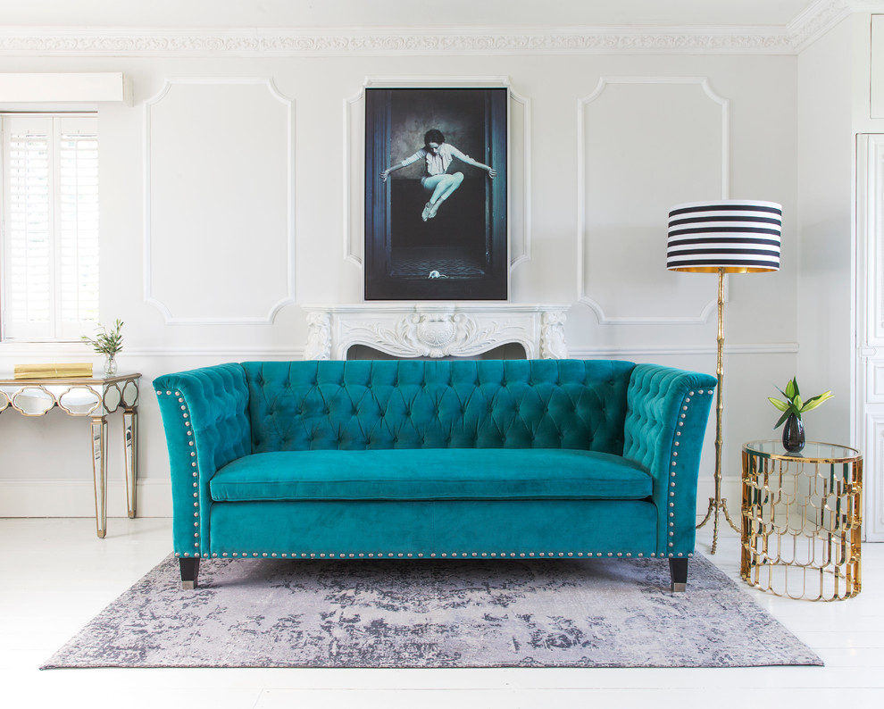 Photo of a traditional formal and grey and teal living room in Sussex with beige walls, a standard fireplace and feature lighting.