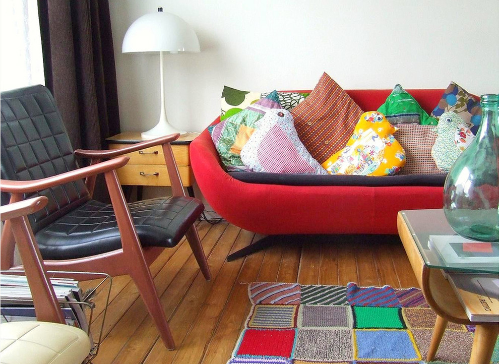 Eclectic medium tone wood floor living room photo in Amsterdam
