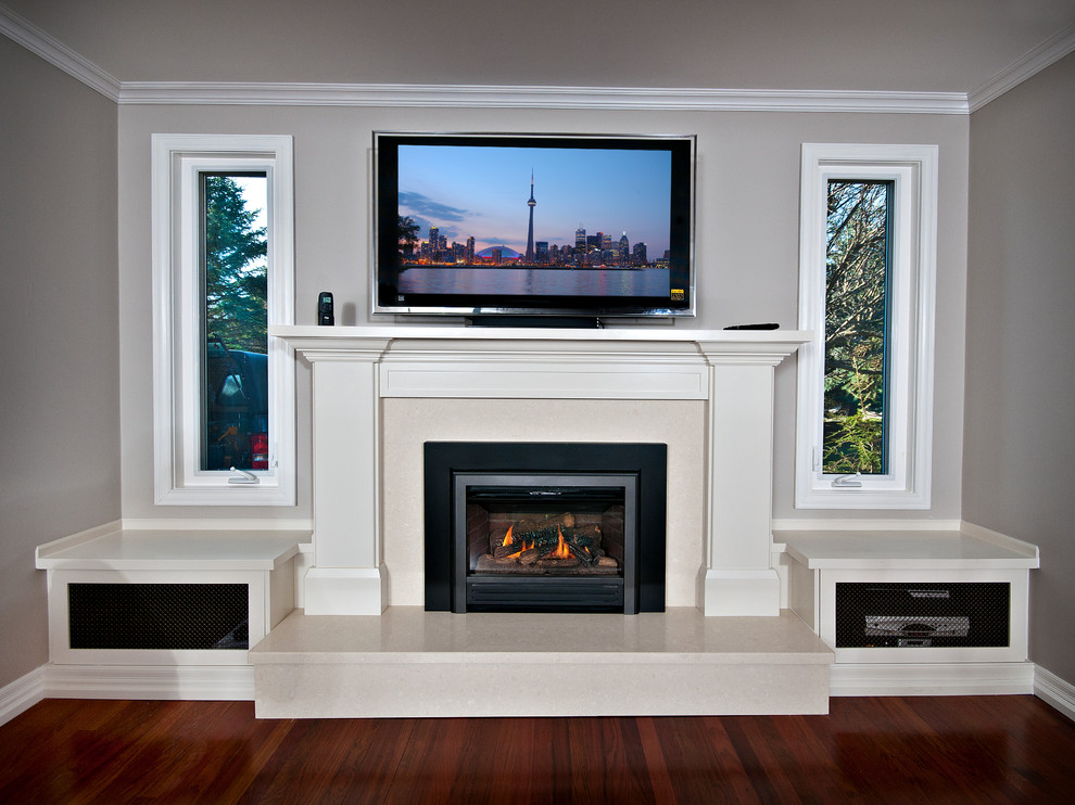 Medium sized traditional open plan living room in Toronto with grey walls, dark hardwood flooring, a standard fireplace, a wooden fireplace surround and a wall mounted tv.