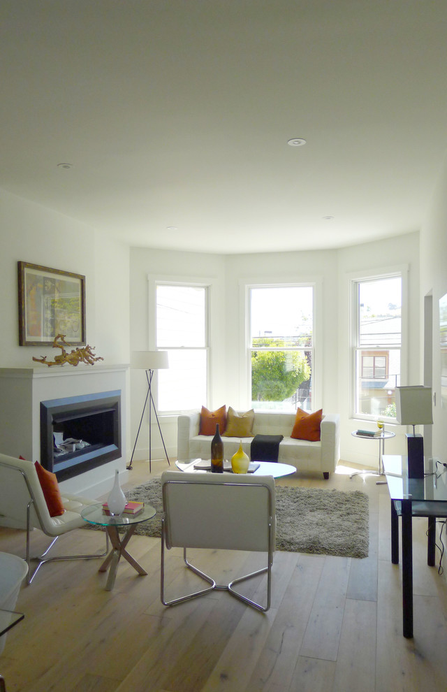 Inspiration for a small contemporary light wood floor living room remodel in San Francisco with white walls