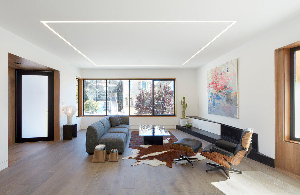 Photo of a contemporary open plan living room in San Francisco with white walls, dark hardwood flooring, a ribbon fireplace and brown floors.