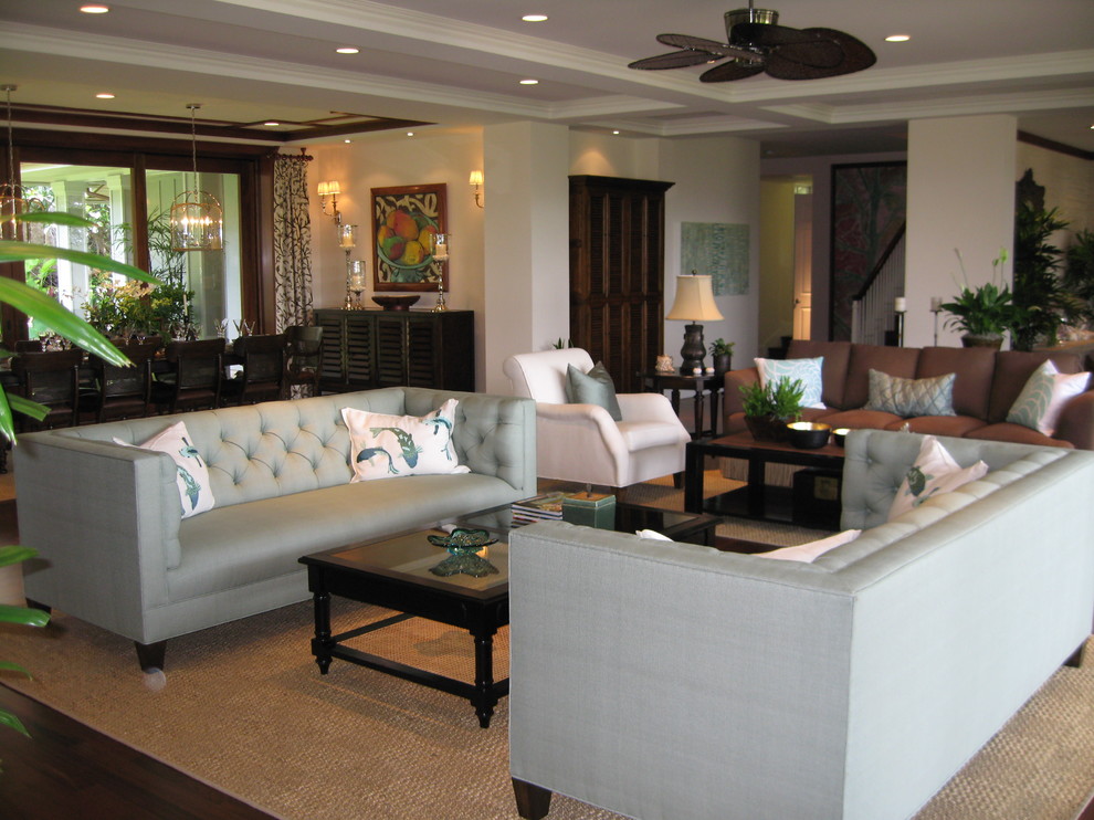 This is an example of a large world-inspired living room in Orange County with beige walls, dark hardwood flooring and no fireplace.
