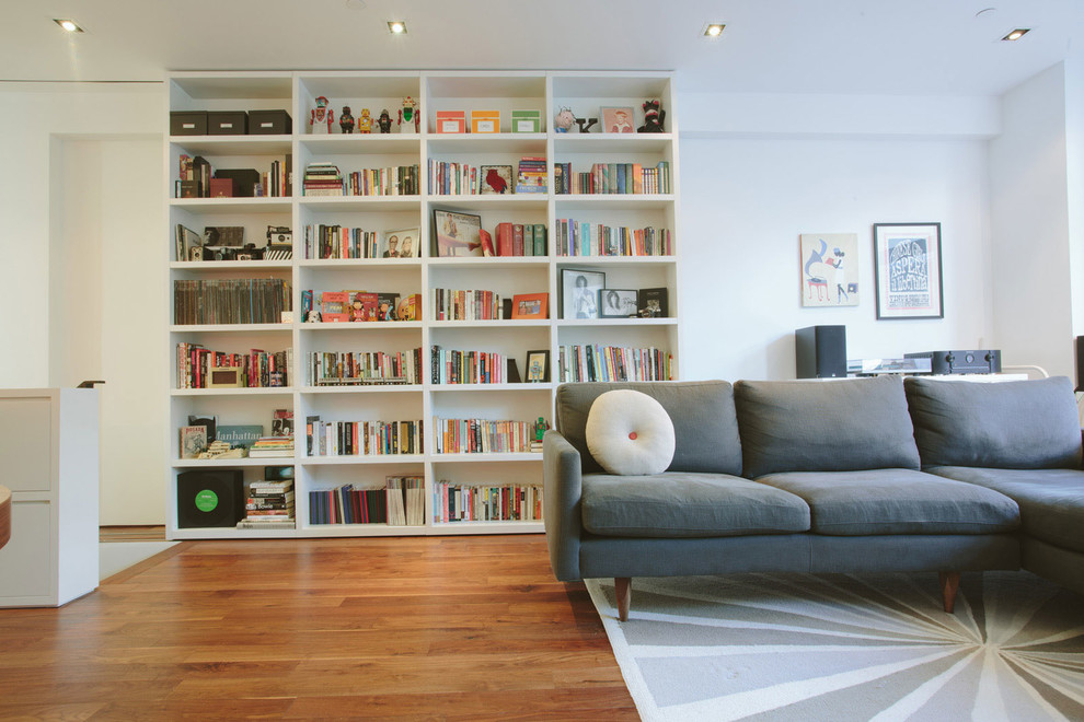 Living room - small contemporary open concept and formal medium tone wood floor living room idea in New York with white walls