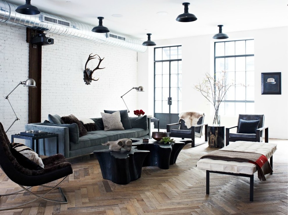 Inspiration for a large industrial loft-style medium tone wood floor living room remodel in New York with white walls and a wall-mounted tv