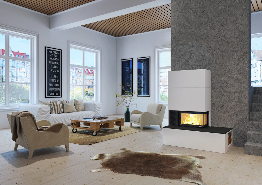 Imagen de salón abierto nórdico grande con paredes grises, suelo de madera clara, estufa de leña y marco de chimenea de hormigón