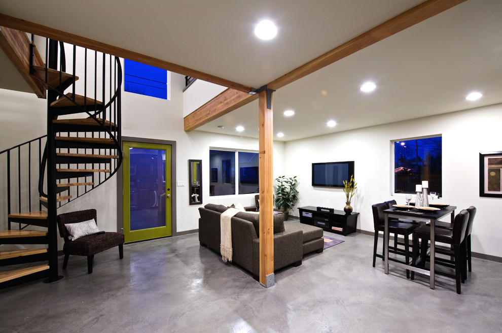 На фото: гостиная комната в современном стиле с бетонным полом и белыми стенами с