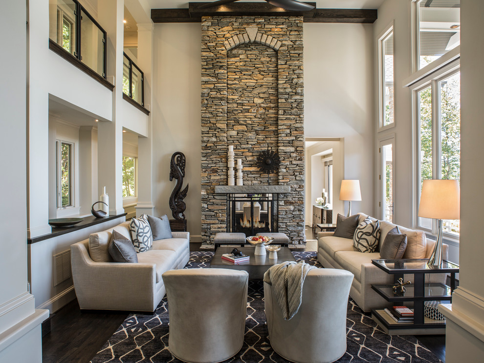 Photo of a large classic open plan living room in Other with a home bar, beige walls, dark hardwood flooring, a two-sided fireplace, a stone fireplace surround and no tv.