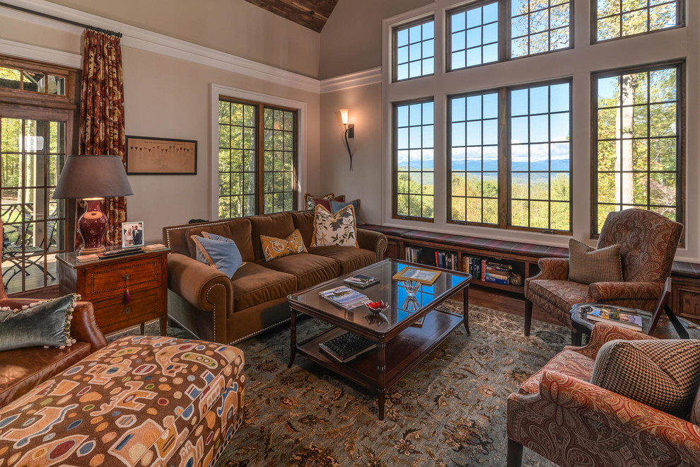 This is an example of a rustic living room in Boston with beige walls and dark hardwood flooring.