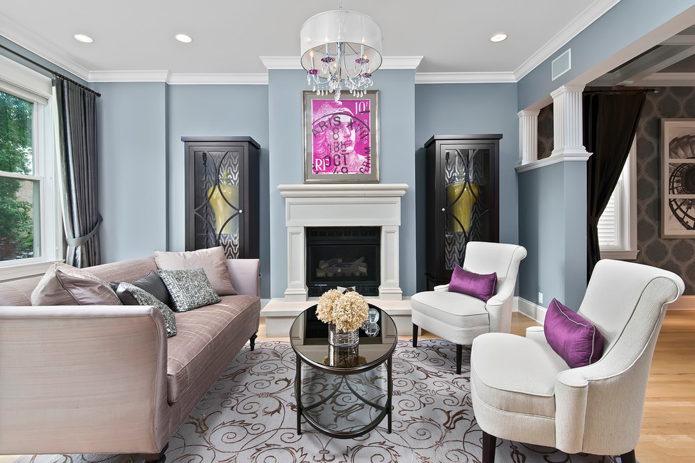 This is an example of an expansive traditional formal open plan living room in Chicago with blue walls, light hardwood flooring, a standard fireplace, a stone fireplace surround and no tv.