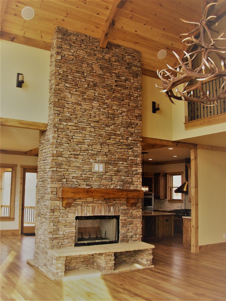 Inspiration for a mid-sized craftsman formal and open concept light wood floor living room remodel in Atlanta with beige walls, a standard fireplace, a stone fireplace and no tv