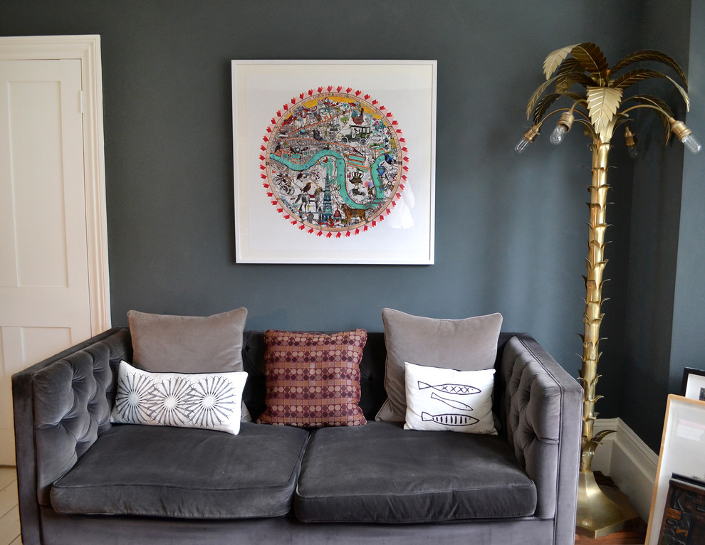 This is an example of an eclectic living room in London with grey walls.