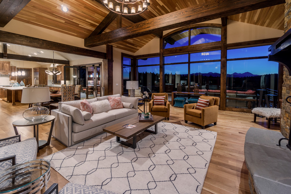 Photo of a large world-inspired formal open plan living room in Other with medium hardwood flooring, a standard fireplace, a stone fireplace surround and a built-in media unit.