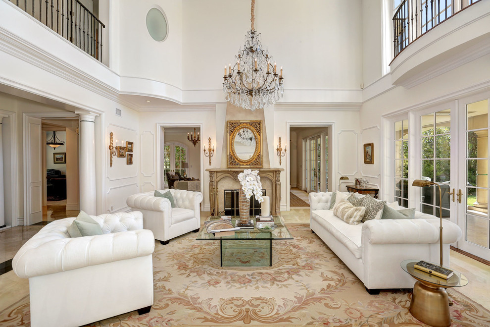 Classic formal enclosed living room in Los Angeles with white walls, a standard fireplace, no tv and beige floors.