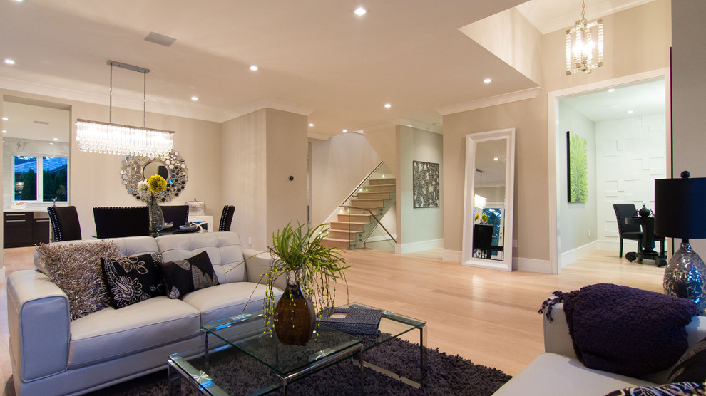 Immagine di un soggiorno design con pareti beige e parquet chiaro