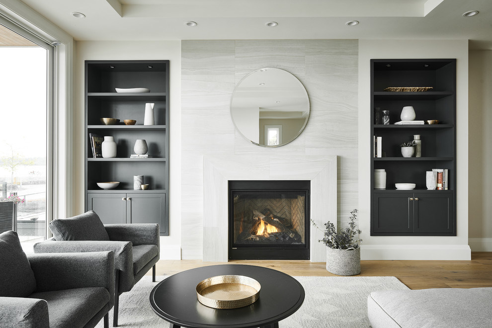 Medium sized contemporary formal and grey and black open plan living room in Vancouver with a standard fireplace, white walls, light hardwood flooring, a metal fireplace surround and no tv.