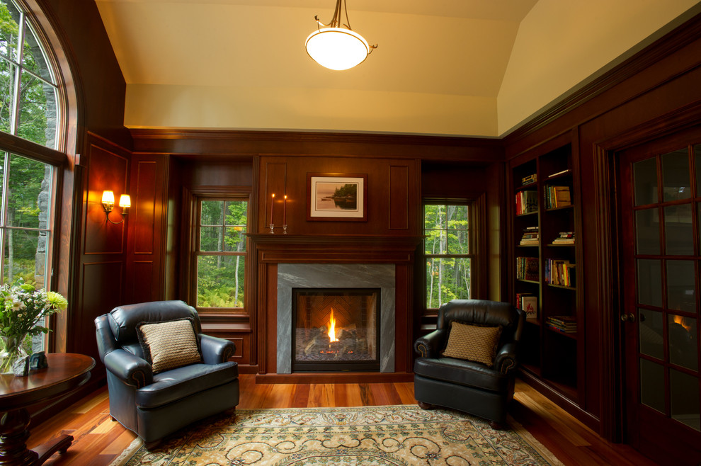 Réalisation d'un salon tradition de taille moyenne et fermé avec une bibliothèque ou un coin lecture, un sol en bois brun, une cheminée standard et un manteau de cheminée en bois.