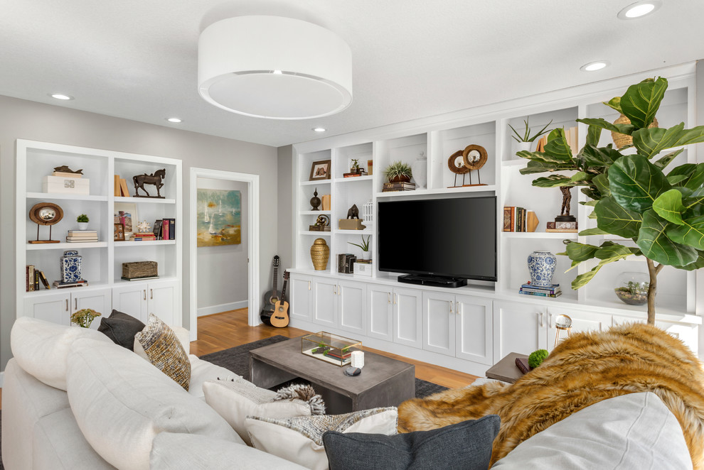 Idee per un soggiorno tradizionale con pareti grigie, pavimento in legno massello medio e pavimento marrone